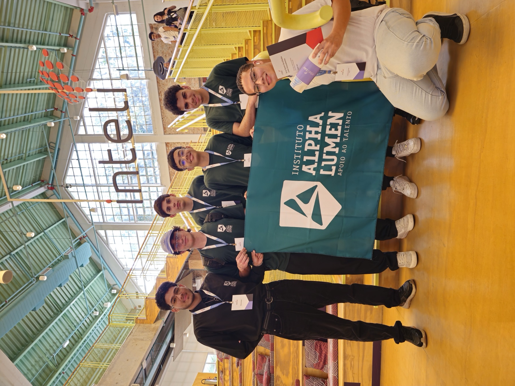 Diego with other Instituto Alpha Lumen students holding the school flag