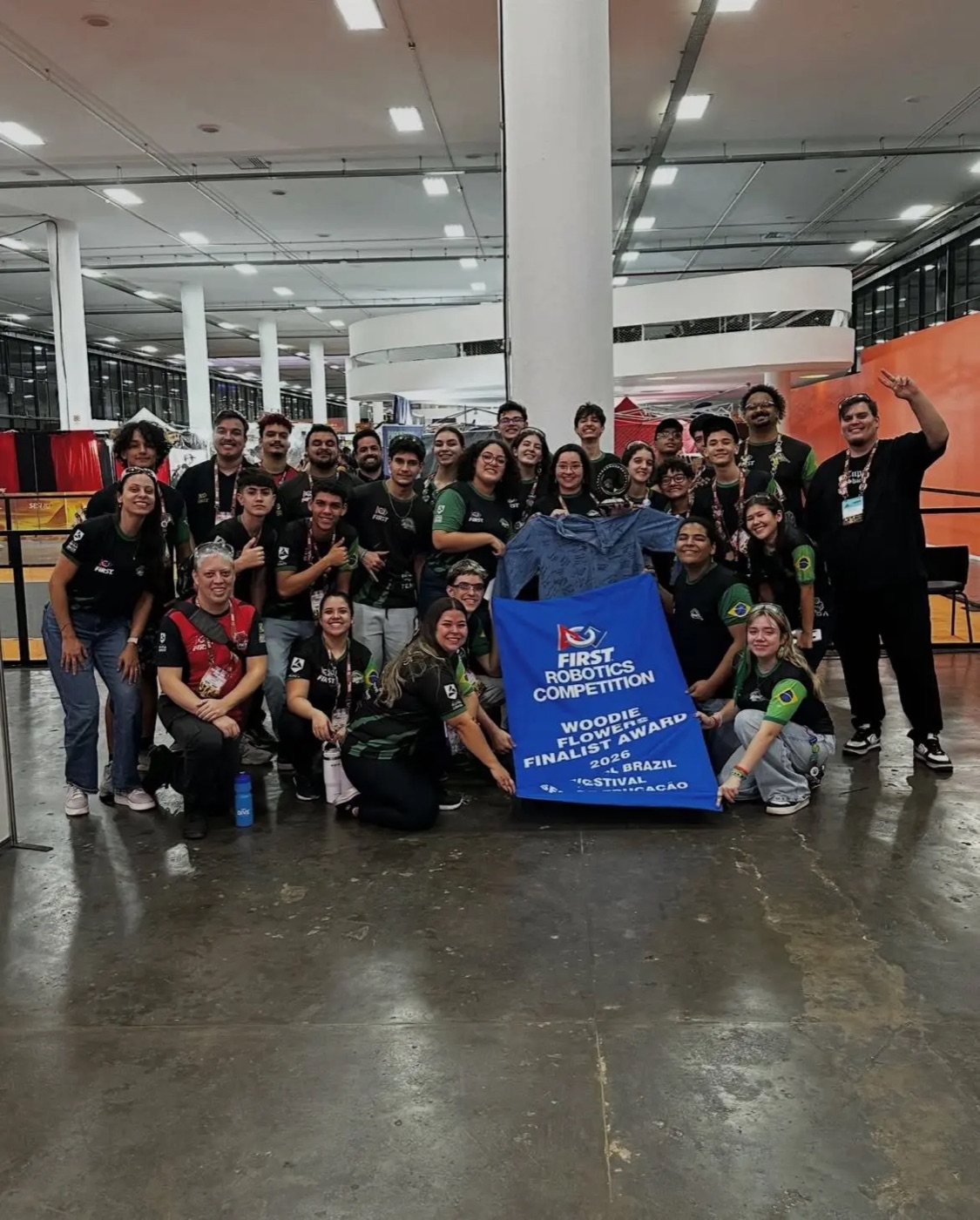 The AlphaBots FIRST Robotics Competition team with its award banner
